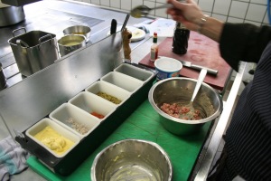 Seasoning the Tartare, with freshly made mayonaise, scallots etc.